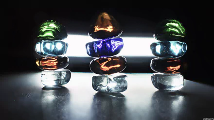 Artistic 4K Ultra HD PC desktop wallpaper: backlit amber and colored crystal stones stacked in three glowing columns against a dark reflective background.