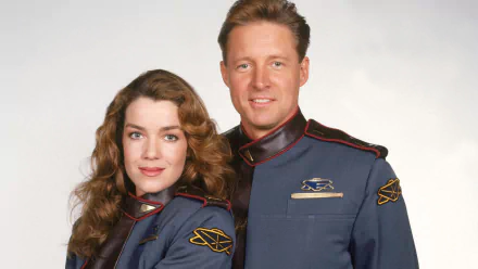 HD PC wallpaper from TV show Babylon 5 featuring commanders John Sheridan and Susan Ivanova in blue-gray uniforms posed against a pale background.