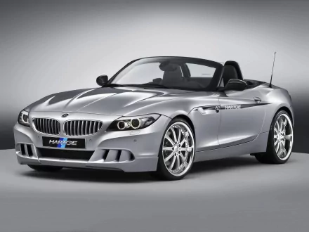HD desktop wallpaper featuring a sleek silver BMW convertible sports car against a neutral background.