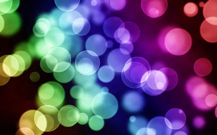 HD desktop wallpaper with a gradient of rainbow colors and artistic, colorful circles and bubbles creating a vibrant background.