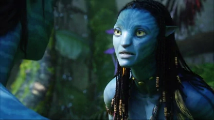 Neytiri from the movie Avatar is depicted in this HD desktop wallpaper, showcasing her vibrant blue features and expressive demeanor against a lush, natural backdrop.