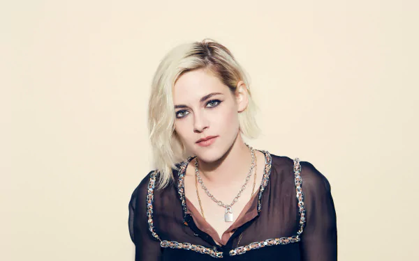 Portrait of blonde American actress Kristen Stewart with green eyes, captured in high-resolution for an 8K Ultra HD PC desktop wallpaper.