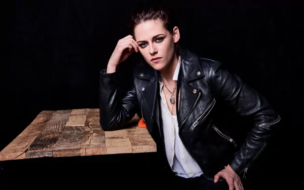Portrait of American actress Kristen Stewart with brunette hair and green eyes, wearing a black leather jacket, set against a dark background in 8K Ultra HD quality.