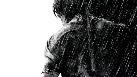 HD desktop wallpaper and background featuring a dramatic scene from the movie Rambo, showcasing the protagonist from behind in the rain.