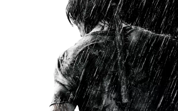 HD desktop wallpaper and background featuring a dramatic scene from the movie Rambo, showcasing the protagonist from behind in the rain.
