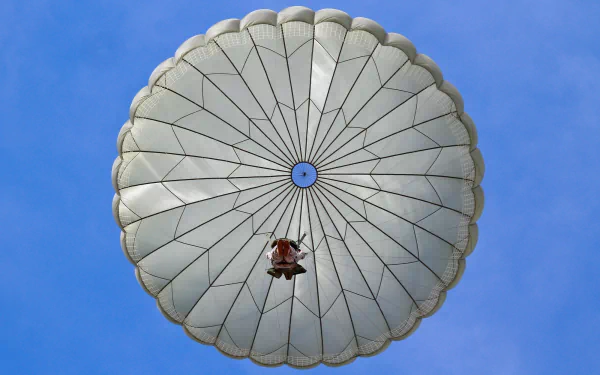  Maj. Russell Anderson descends to the ground after jumping from a C-130 Hercules aircraft by Sgt. Matt Hech