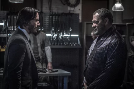 HD wallpaper featuring Laurence Fishburne and Keanu Reeves in a scene from the movie John Wick: Chapter 2 with dark background and weapon display.