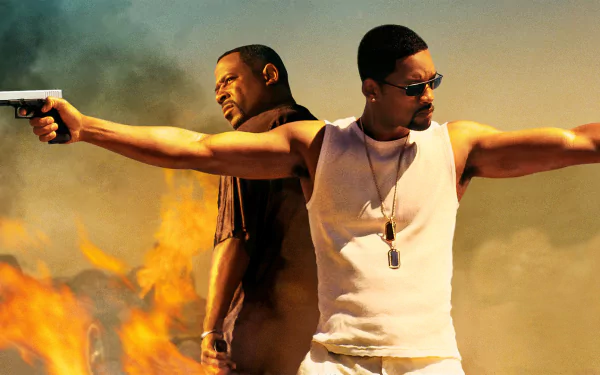 HD PC desktop wallpaper of Bad Boys II: two men back-to-back, arms outstretched holding pistols, wearing dog tags and sunglasses, flames and a smoky sky behind them.