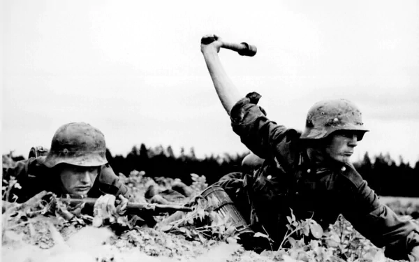 HD desktop wallpaper showing two military soldiers in combat gear, one throwing a grenade while lying in a field.