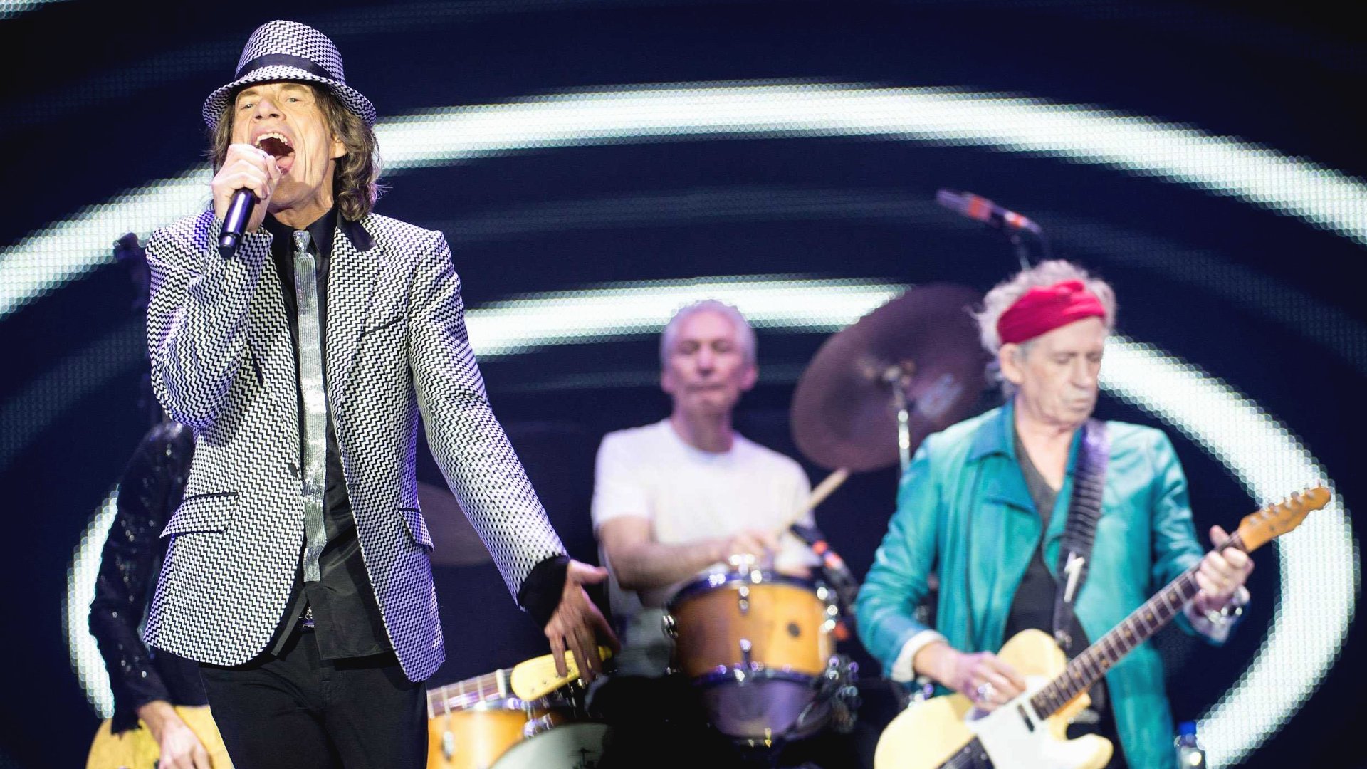 HD desktop wallpaper featuring The Rolling Stones performing live, capturing the band's iconic music energy and stage presence.