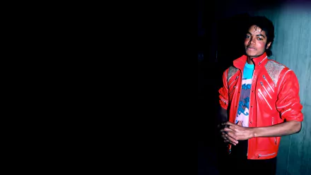 HD PC desktop wallpaper featuring Michael Jackson in a red jacket against a dark background, capturing his iconic music legacy.