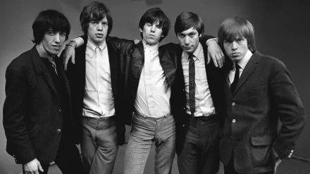 Black-and-white HD desktop wallpaper featuring The Rolling Stones band members posing together in stylish 1960s attire.