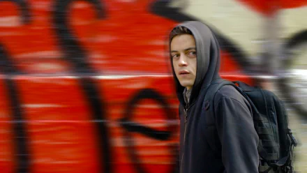 HD PC desktop wallpaper of a hoodie-clad figure from the TV show Mr. Robot walking past blurred red graffiti.