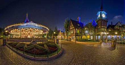 A beautifully lit Disneyland carousel and Tudor-style buildings at night, captured in stunning 4K Ultra HD for a vibrant PC desktop wallpaper.