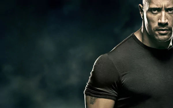 HD desktop wallpaper: close-up of a stern, muscular man in a black shirt against a smoky background, styled like a poster still from the movie Faster.