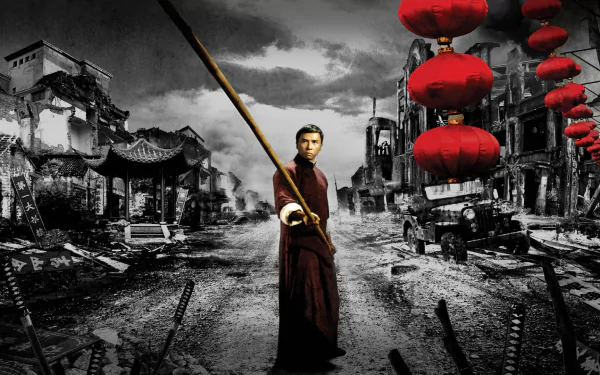 HD PC desktop wallpaper/background from the Ip Man movie: lone martial artist in robes holding a staff on a ruined street, bright red lanterns against a grayscale cityscape.