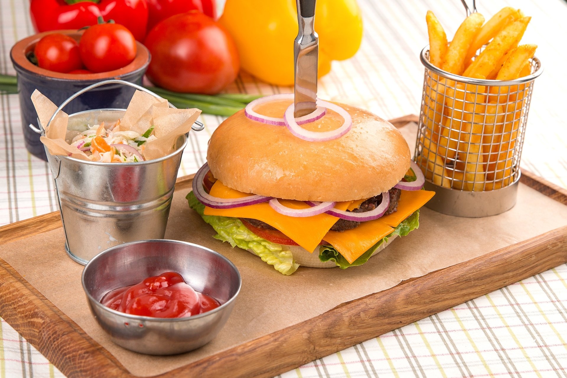 HD still life of a cheeseburger with lettuce and onion, served with golden french fries and ketchup, presented as a vibrant PC desktop wallpaper background.