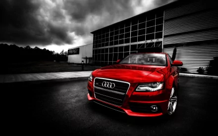 A striking Audi A4 in vibrant red, showcased against a dramatic dark backdrop, creating an eye-catching HD desktop wallpaper.