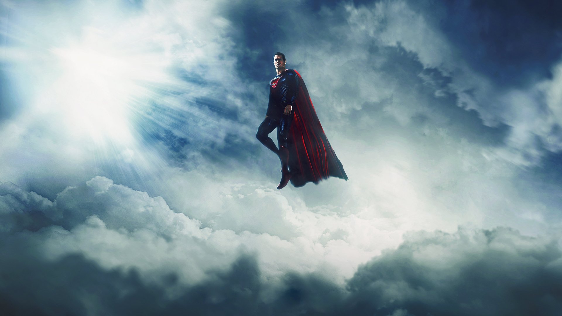 HD wallpaper of Henry Cavill as Superman from the Man of Steel movie, soaring confidently above the clouds against a dramatic sky background.