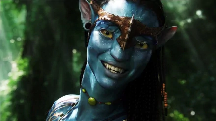 Neytiri from Avatar features long brown hair, striking yellow eyes, and intricate jewelry, showcasing her fierce beauty and connection to nature in this vibrant HD wallpaper.