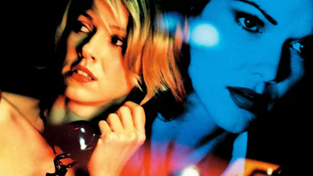 HD desktop wallpaper: two women in cinematic close-up with split blue-orange lighting, one holding a phone, moody Hollywood-noir atmosphere.