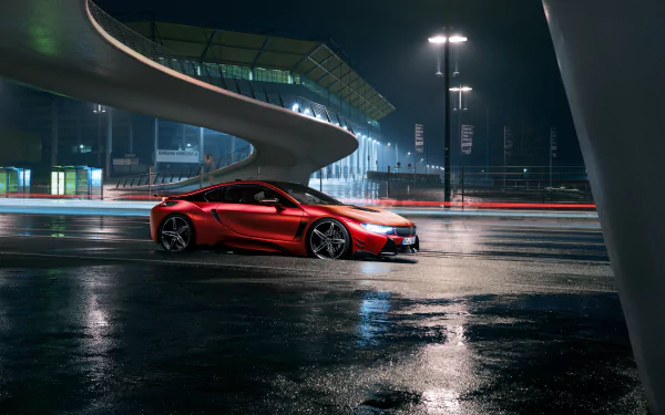 A sleek red BMW i8 supercar parked under modern architecture at night, captured in a 4K Ultra HD desktop wallpaper showcasing its dynamic design.