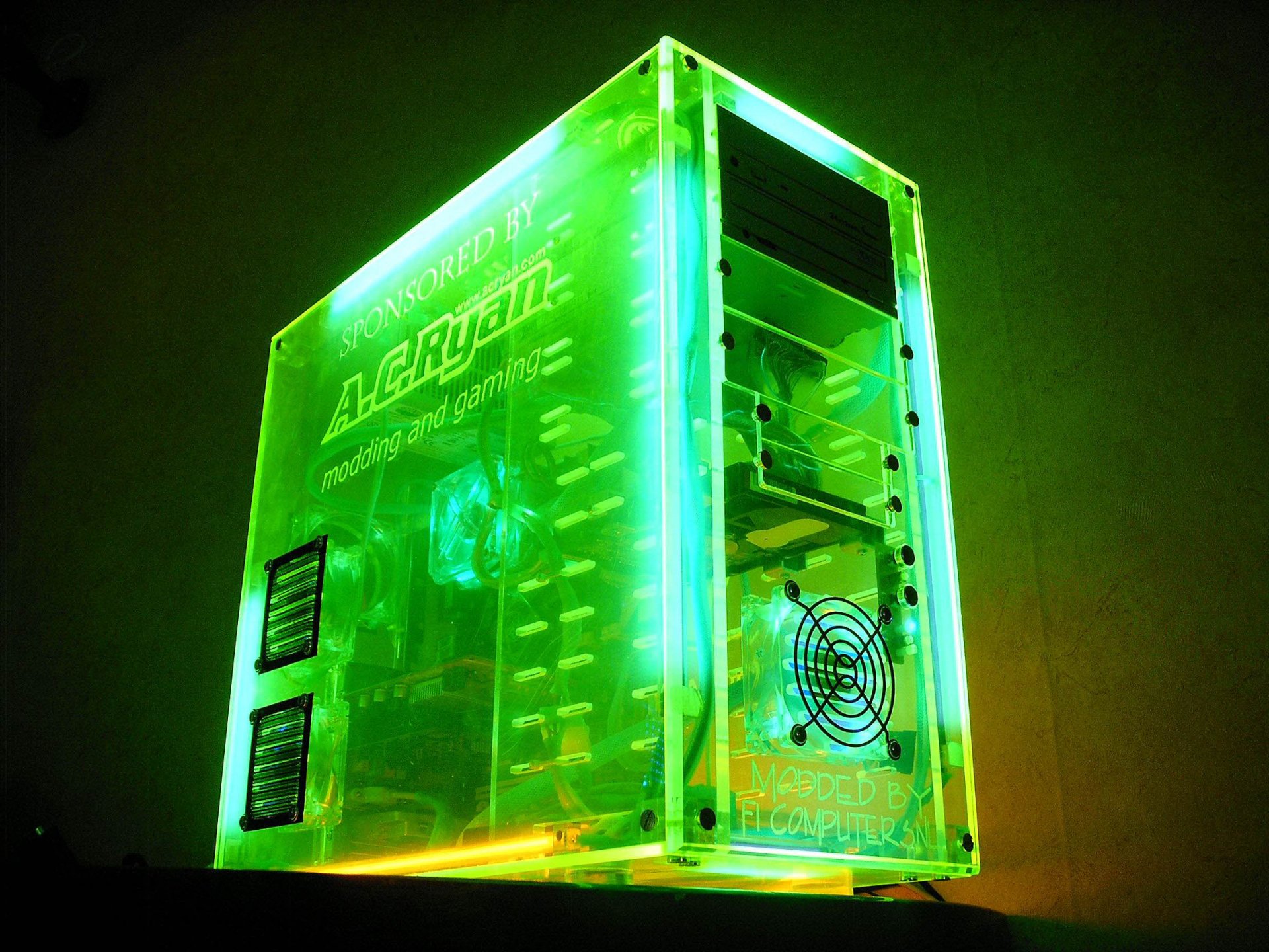 HD PC desktop wallpaper showcasing a glowing green transparent computer tower, highlighting advanced technology and hardware components in vivid detail.