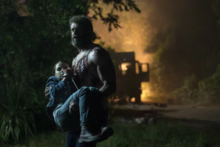 HD desktop wallpaper of the movie Logan featuring Hugh Jackman as Wolverine carrying Dafne Keen as Laura Kinney (X-23), with a dramatic night-time background.