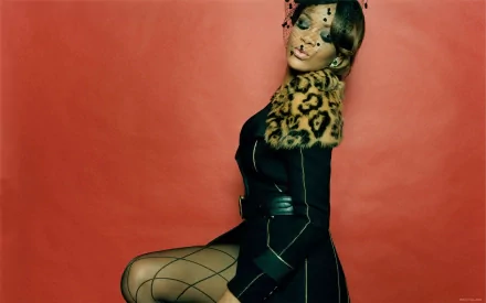 HD desktop wallpaper featuring Rihanna, showcasing her stylish pose against a vibrant red background, adorned with a leopard print accessory. A striking blend of fashion and music.