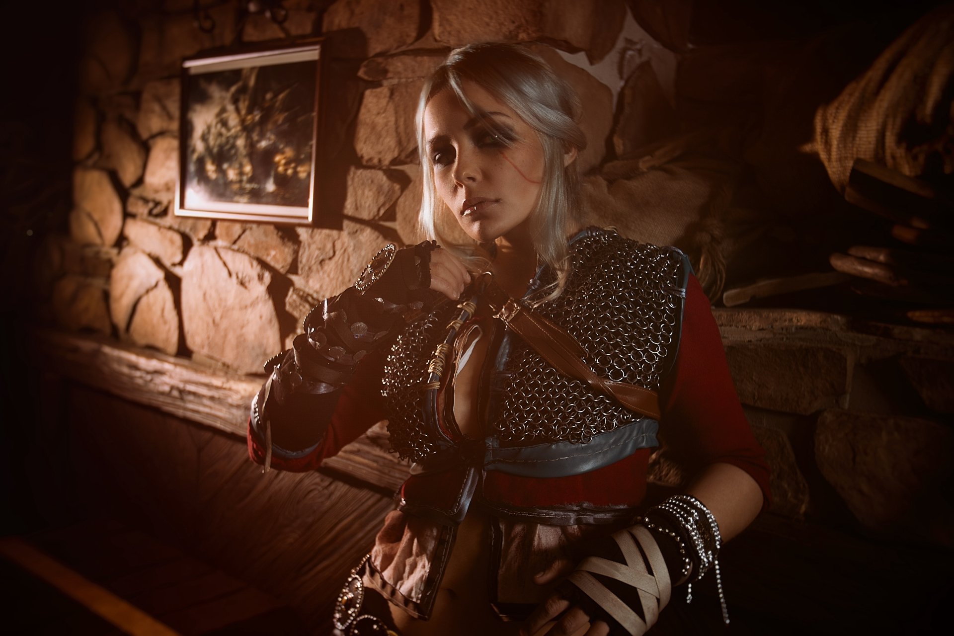 Ciri from The Witcher portrays a confident woman in detailed cosplay, illuminated against a rustic background, captured in stunning 4K Ultra HD resolution.