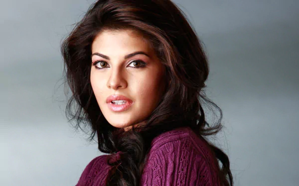 Close-up portrait of brunette celebrity Jacqueline Fernandez with brown eyes and lipstick, captured in a high-definition desktop wallpaper and background.
