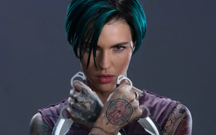 HD desktop wallpaper featuring actress Ruby Rose with short hair and tattoos, holding knives. This image is from the movie xXx: Return of Xander Cage.