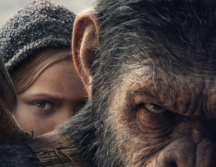 HD desktop wallpaper and background from the movie War For The Planet Of The Apes, featuring a close-up of an ape's intense gaze with a young person in a hooded sweater partly visible behind.