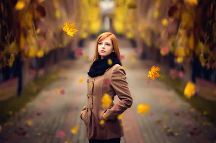 A redhead woman wearing a scarf and coat stands on a leafy path in fall, with autumn leaves falling and a soft depth of field creating a moody HD desktop wallpaper.