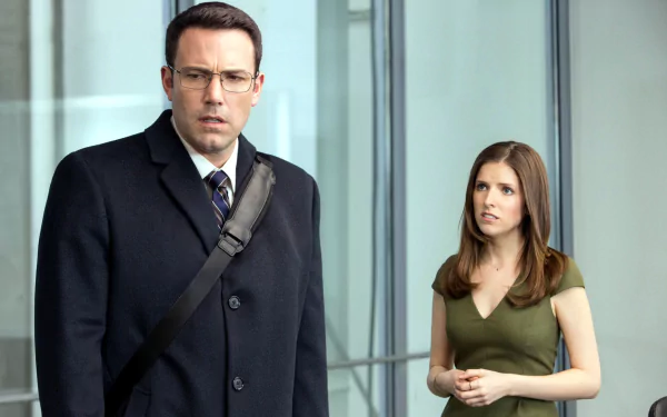 HD wallpaper featuring Anna Kendrick and Ben Affleck in a scene from the movie The Accountant, standing in a modern glass-walled building.