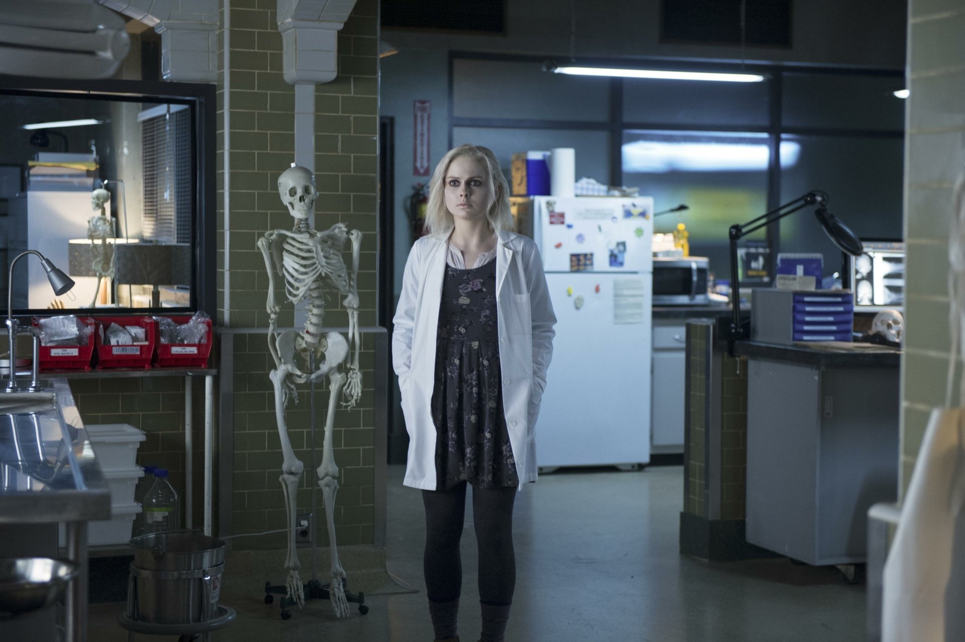HD desktop wallpaper featuring Rose McIver as Liv Moore from the TV show iZombie, standing next to a skeleton in a lab setting.