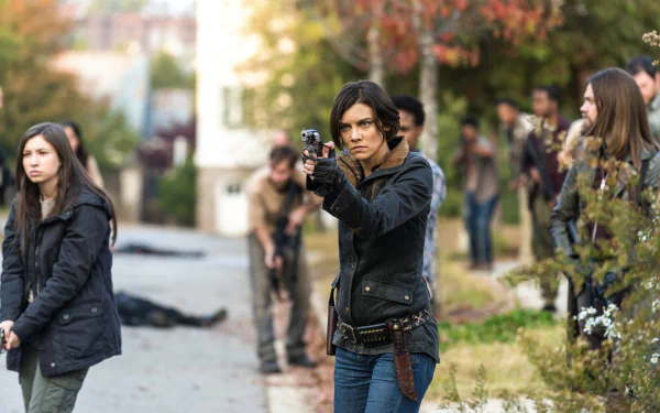 Tom Payne as Jesus and Katelyn Nacon as Enid from The Walking Dead in a tense street scene, captured in 4K Ultra HD for a PC desktop wallpaper.