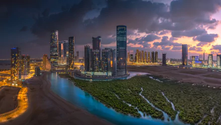 HD desktop wallpaper of Abu Dhabi at night, showcasing illuminated skyscrapers near water and lush greenery, with the cityscape set against a dramatic, cloud-filled sky.