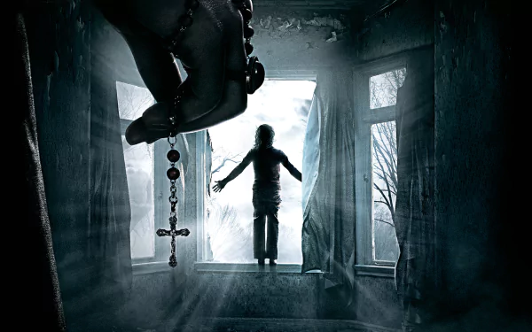 HD wallpaper from The Conjuring 2 shows a dramatic scene with a hand holding a rosary in the foreground, while a silhouetted figure levitates near a window in a dimly lit room.