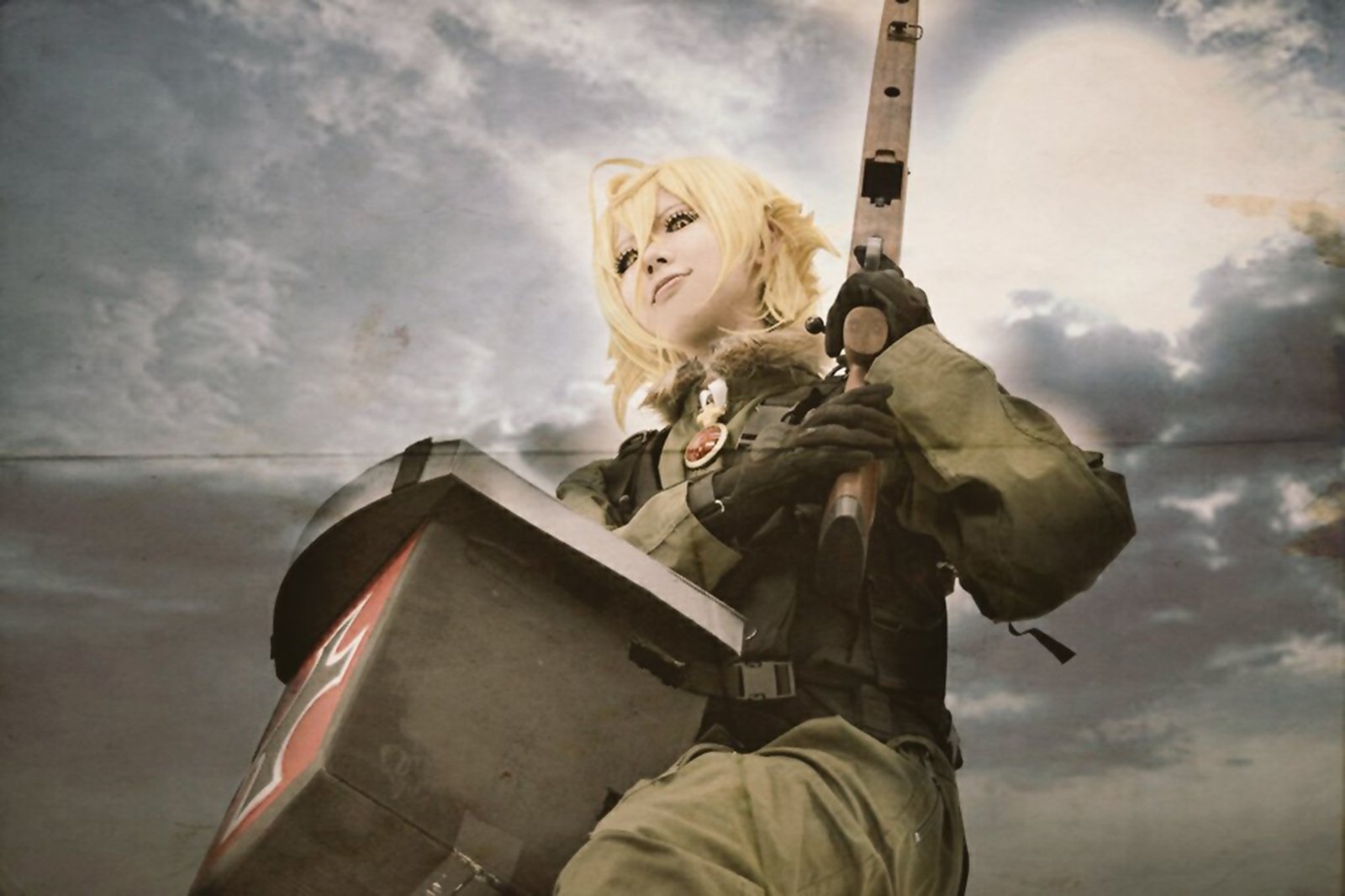 HD desktop wallpaper featuring a cosplay of Tanya Degurechaff from The Saga of Tanya the Evil, set against a dramatic cloudy sky background.