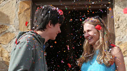 HD desktop wallpaper featuring Asa Butterfield and Britt Robertson smiling amid colorful confetti from the movie The Space Between Us.