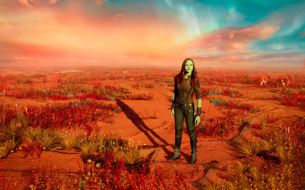 HD PC desktop wallpaper featuring Gamora from Guardians of the Galaxy Vol. 2 standing in a vibrant, otherworldly red landscape under a colorful sky.