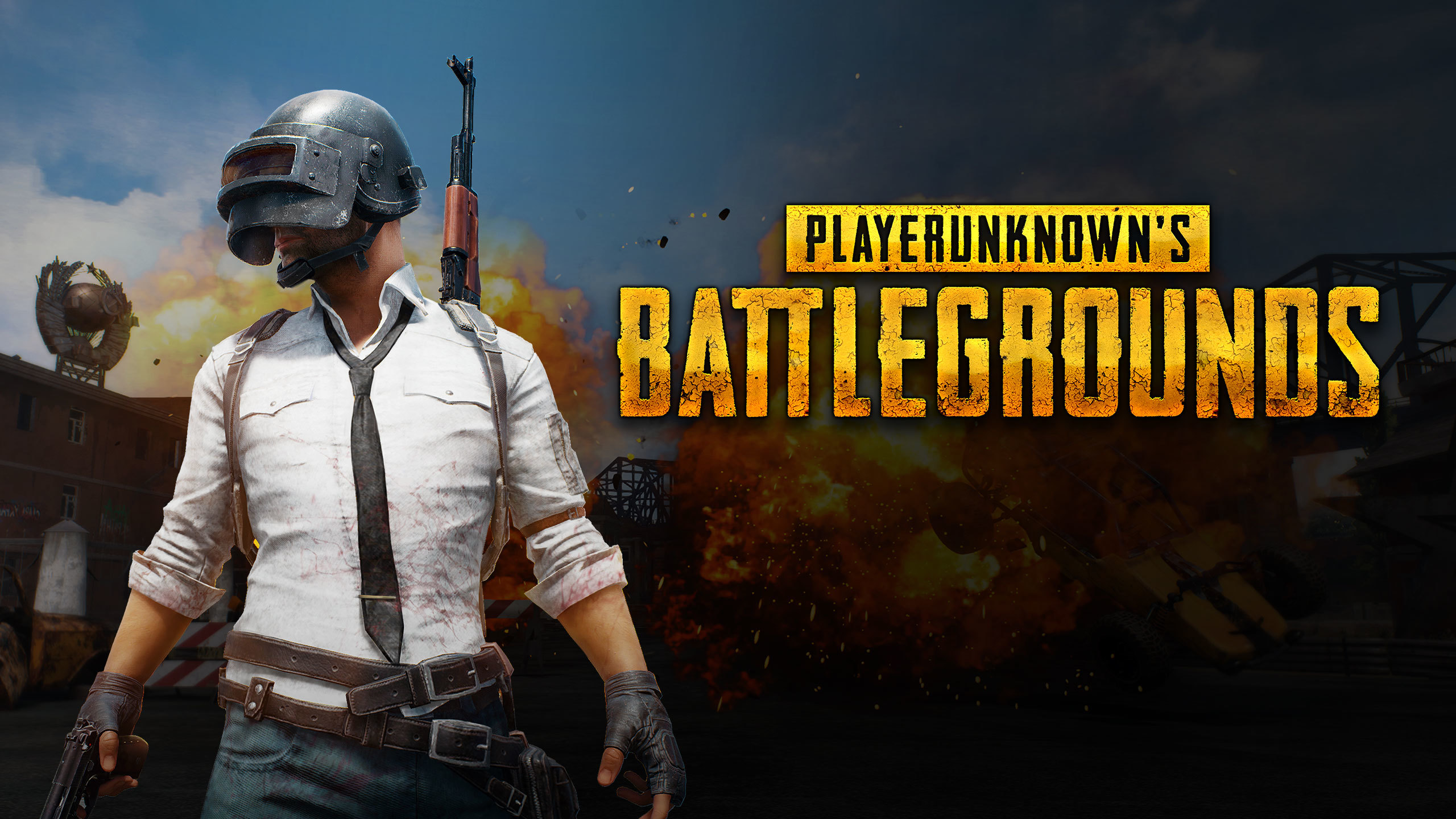 HD desktop wallpaper of Playerunknown's Battlegrounds featuring a character in a helmet and white shirt with explosions in the background.