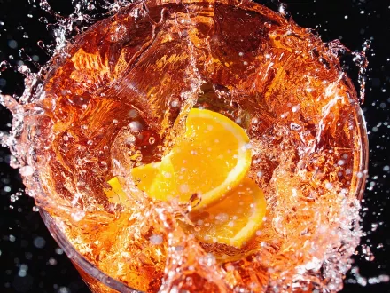 A vibrant HD desktop wallpaper featuring splashes of liquid with lemon slices, creating an energetic and refreshing food-themed background.