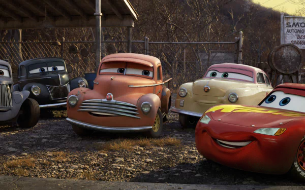 HD desktop wallpaper featuring Lightning McQueen and characters from the movie Cars 3, showcasing them in a rustic outdoor setting with a background of trees and a wooden shed.
