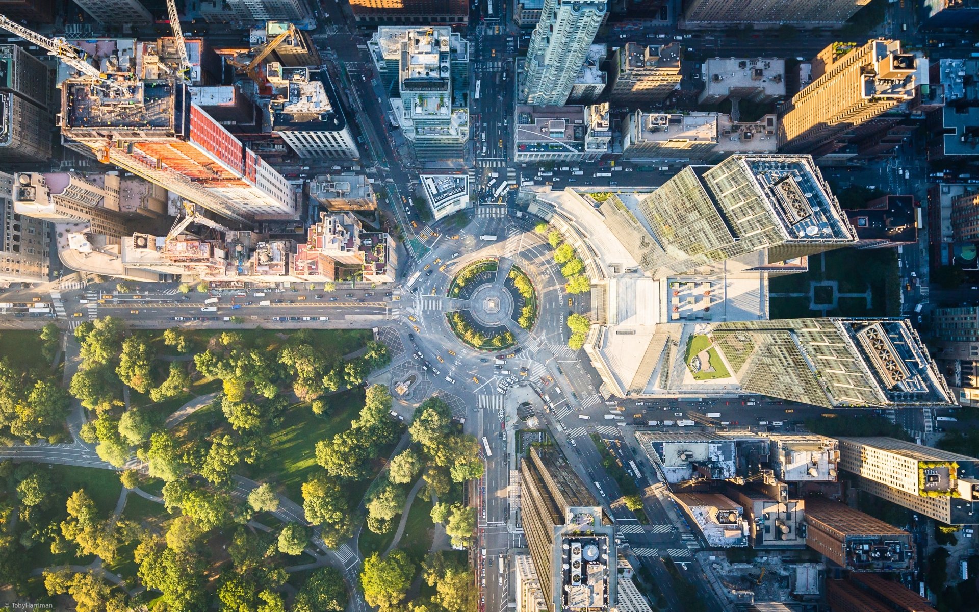 Aerial view of Columbus Circle in New York City, showcasing the circular park surrounded by towering buildings and bustling streets, captured in HD for a desktop wallpaper.