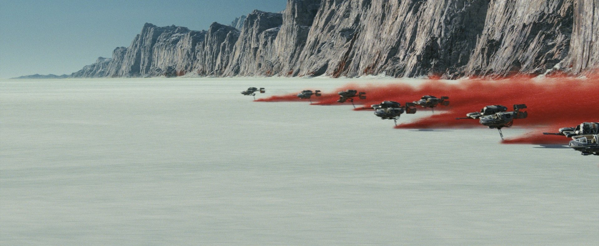 HD desktop wallpaper from Star Wars: The Last Jedi featuring spacecraft flying across a barren landscape, leaving red trails against a rocky backdrop.