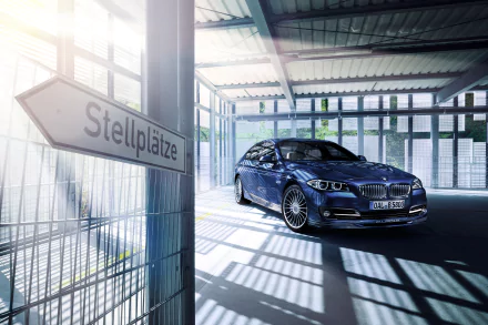 A sleek BMW Alpina B5 Bi-Turbo Limousine parked inside a sunlit garage, captured in crisp 4K Ultra HD for a PC desktop wallpaper.