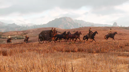 HD desktop wallpaper featuring a scene from Red Dead Redemption 2, depicting a carriage and riders on horseback traversing a vast, picturesque landscape.