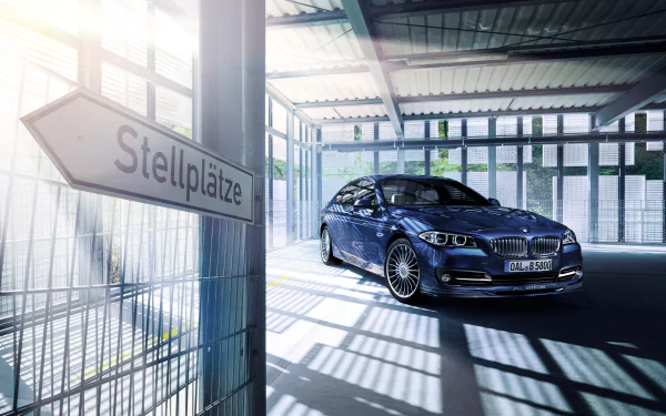 A sleek BMW Alpina B5 Bi-Turbo Limousine parked inside a sunlit garage, captured in crisp 4K Ultra HD for a PC desktop wallpaper.